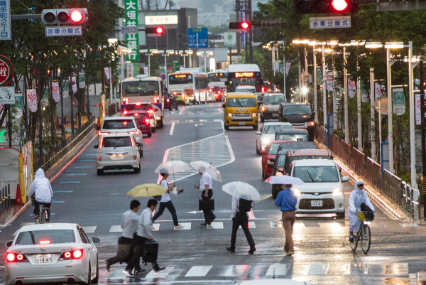 People cross the street in the rain